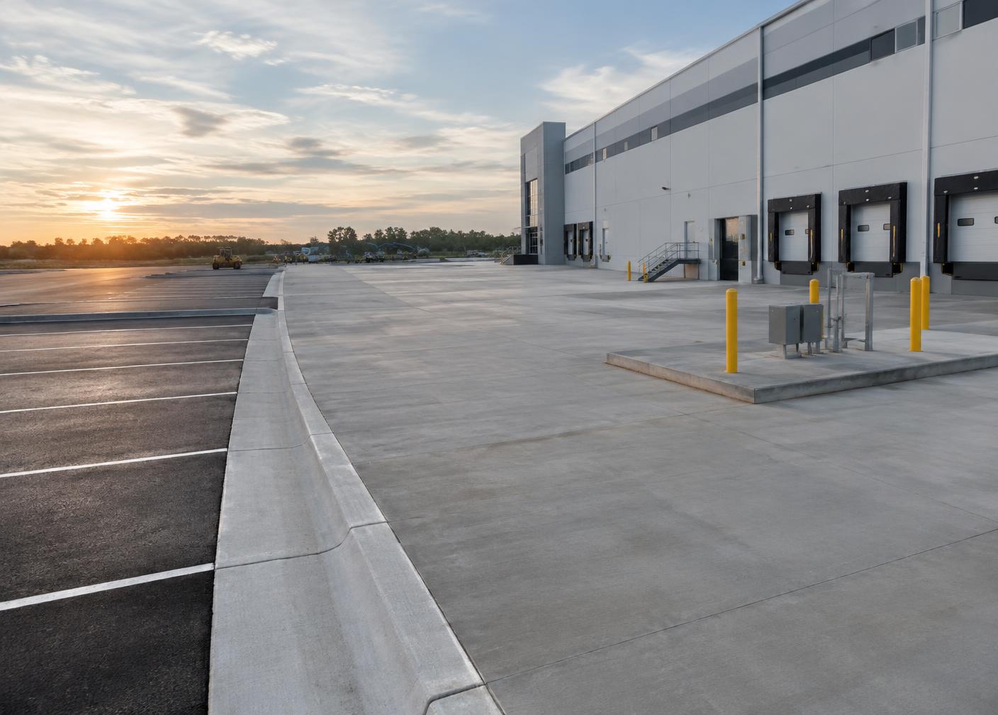 Finished concrete paving, curbs and loading areas at a commercial facility